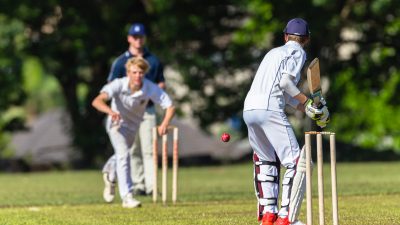 Cricket game teenagers schools game batsman bowler action photo.